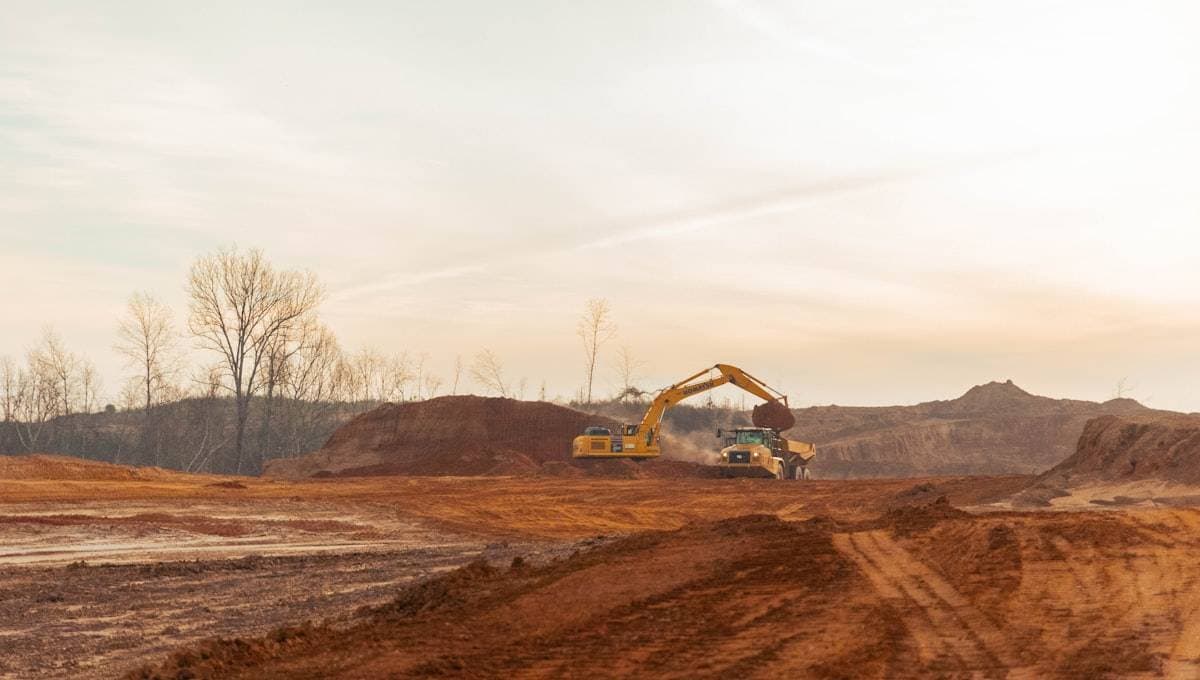 Mining site with haul trucks and mobile plant. MapTrack tracks tooling, plant and fleet across Australian mining operations