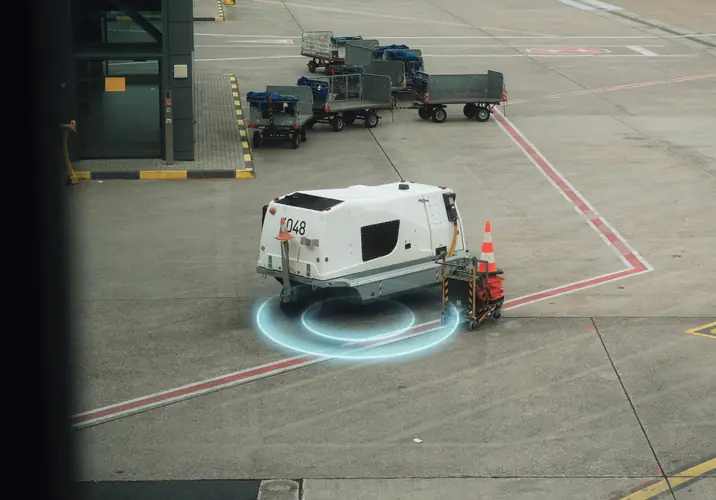 Illustrative site: a ground power unit on its stand at an airport, with MapTrack open on a laptop and a phone beside it.